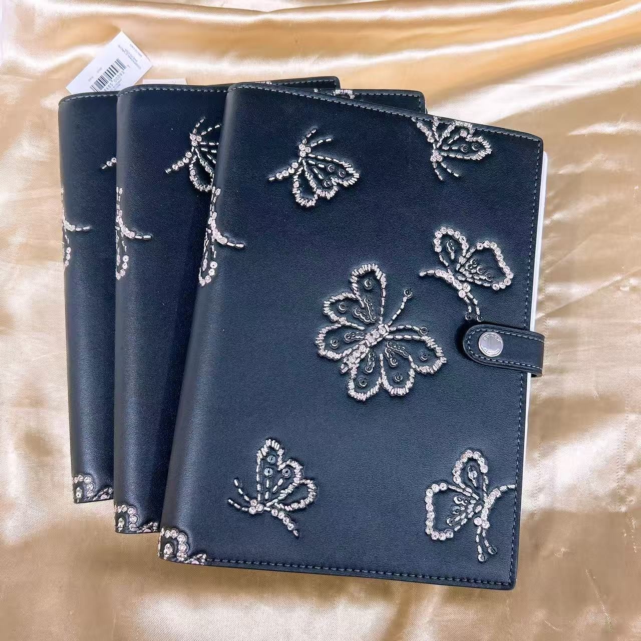 NWT Coach Notebook With Butterfly Print CCF42 (count 1) black color.